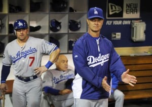 Dodgers manager Don Mattingly cheers on his team while Nick Punto waits for his next at-bat.